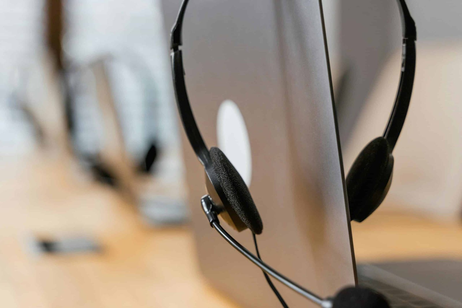 Close-up of a headset resting on a laptop, symbolizing efficient work environment technology.
